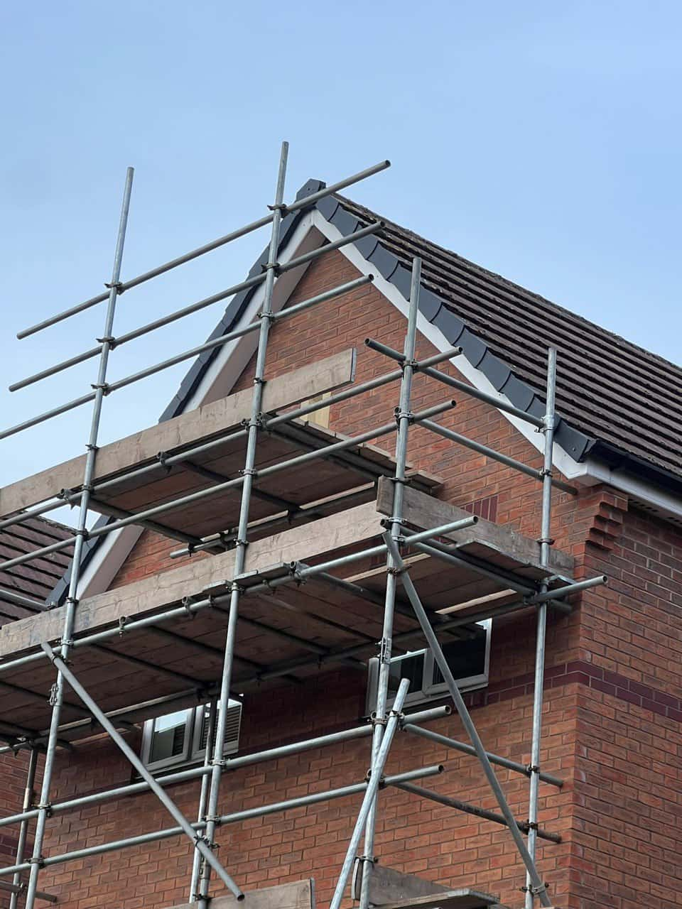 This is a photo of a roof which has just been repaired. There is a scaffold located at the gable end for access onto the roof. Works carried out by Mansfield Woodhouse Roofing Repairs