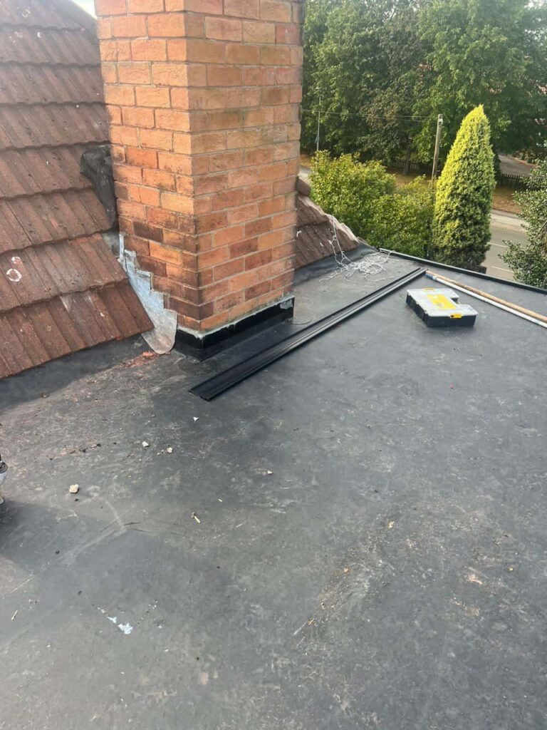 This is a photo of a flat roof which has just been repaired, there is also a chimney stack and some leadwork has also been dressed. Works carried out by Mansfield Woodhouse Roofing Repairs